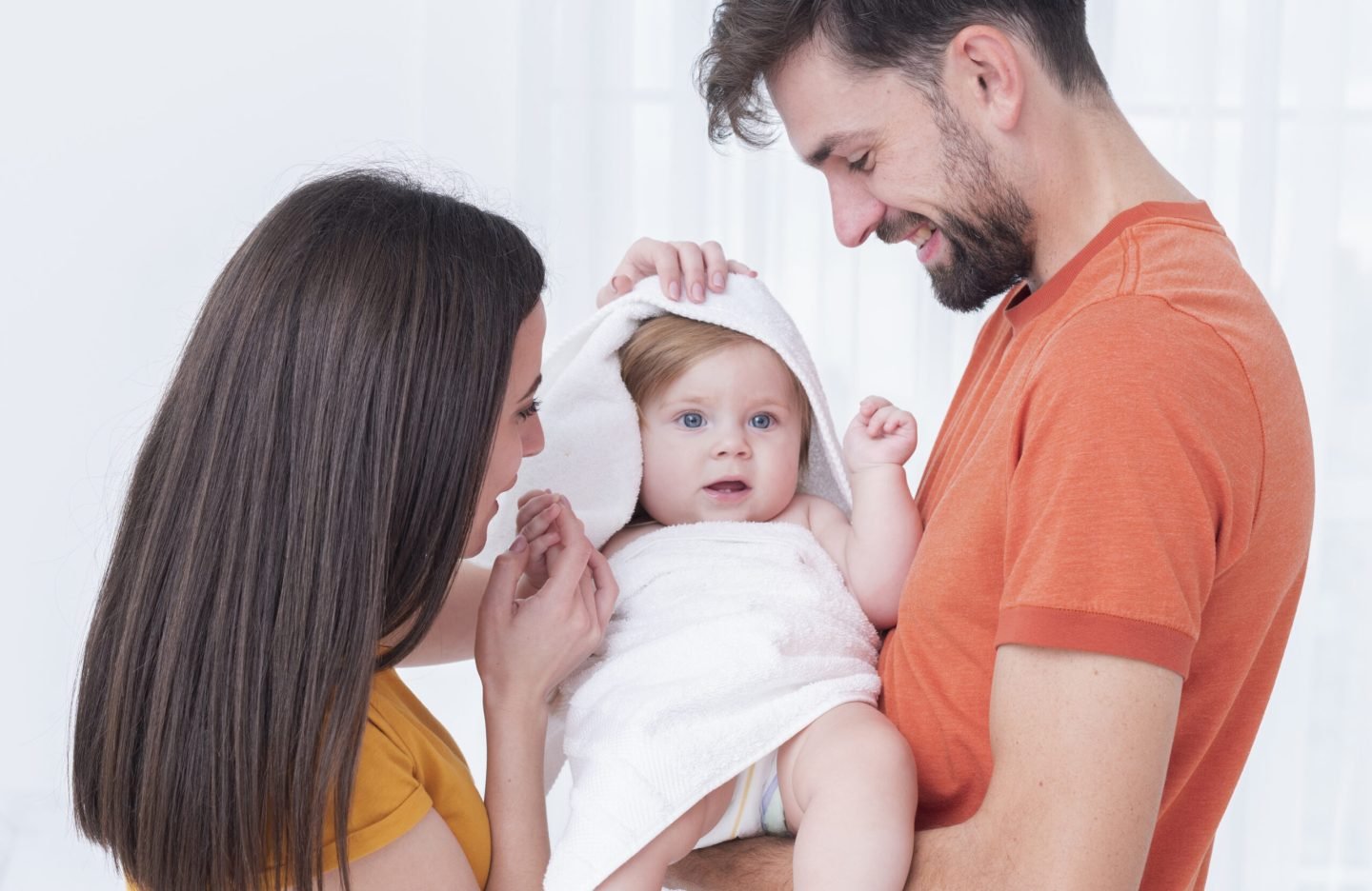 baby-towel-held-by-parents